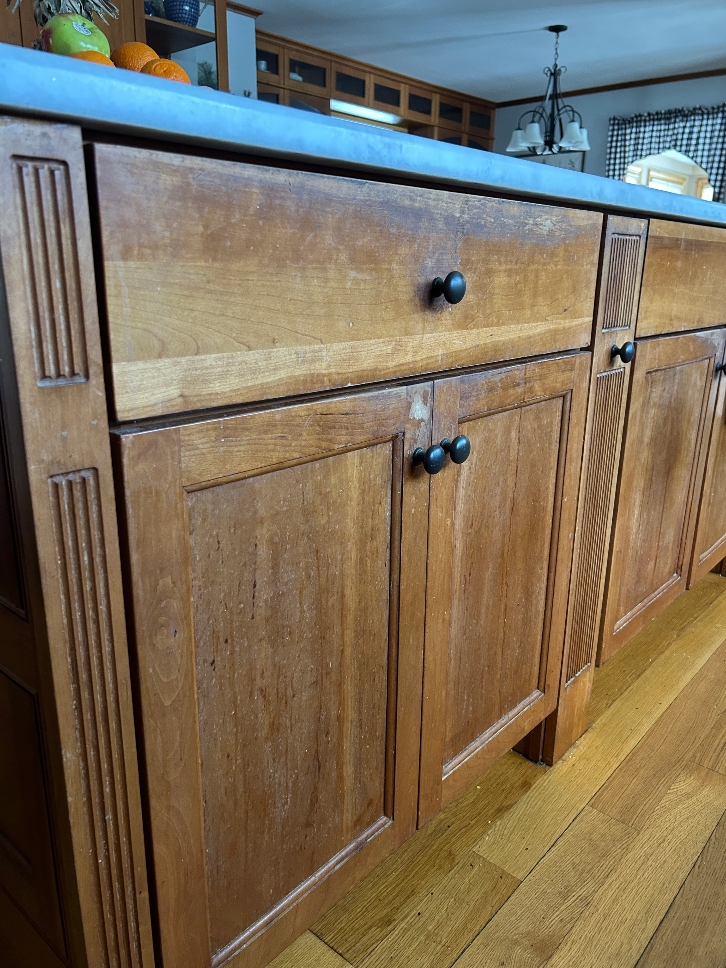 Worn cabinet finish showing need for refinishing